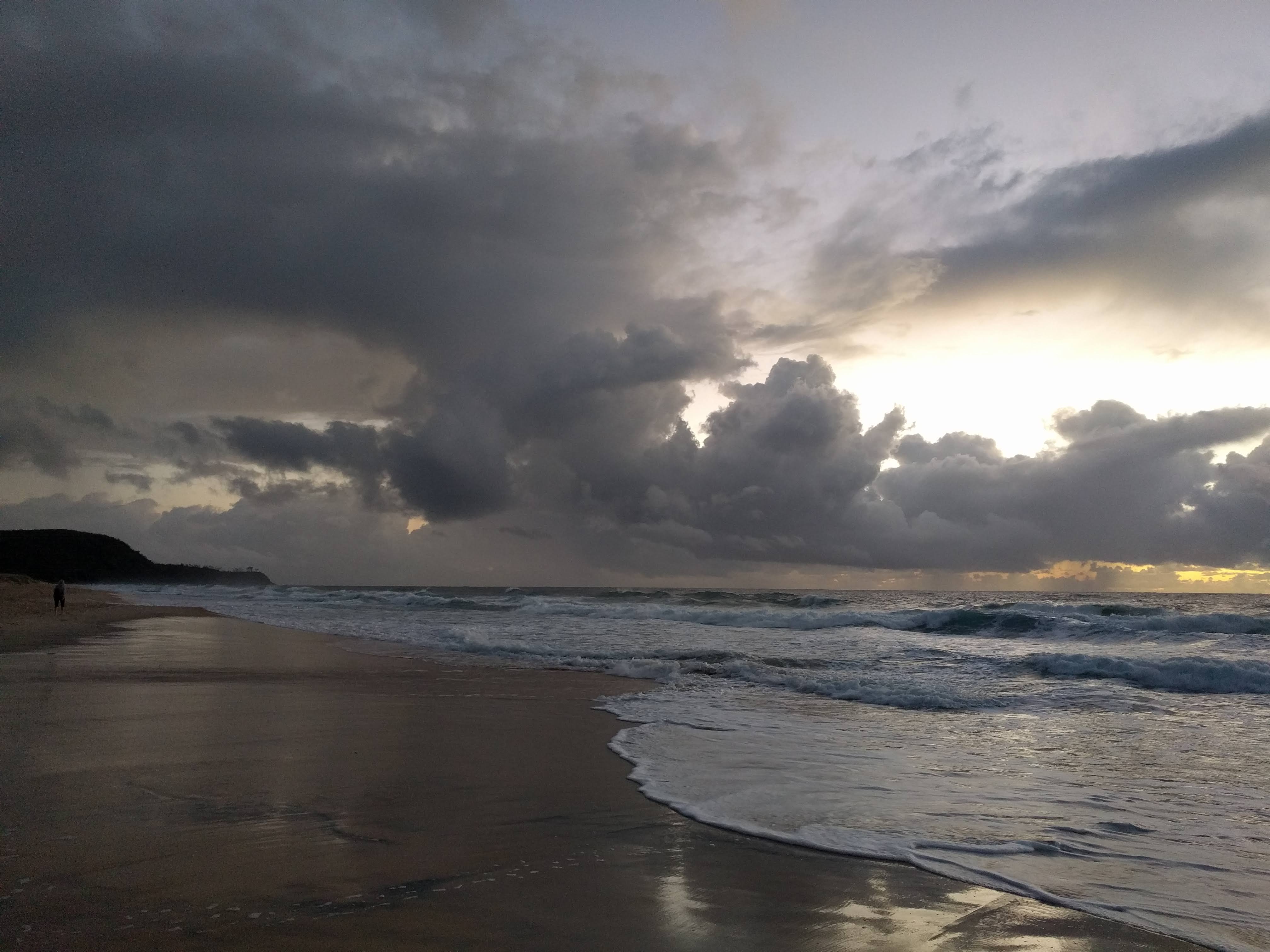 Storm clouds gathering over the beach at sunrise